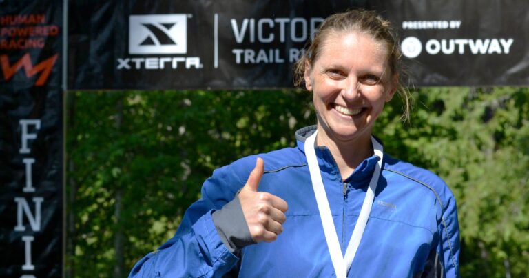 Race poses with her medal at the finish line at the XTERRA Trail Run.